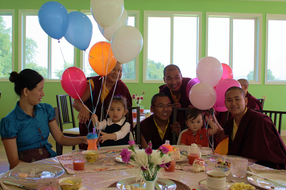 Minling Dungse Rinpoche celebrates his 1st birthday along with his elder sister, Jetsün Rinpoche, Ven. Acarya Namdrol Gyatso la, Ven. Thrinley Gyaltsen al, Anila Choenyid Choedron, Anila Thaye Choedron and Yeshe Choedron.