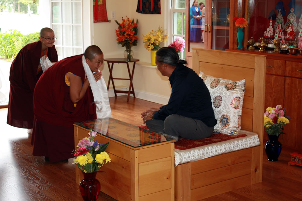 Anila Choenyid offering a khatag to HE Dzigar Kongtrul Rinpoche.
