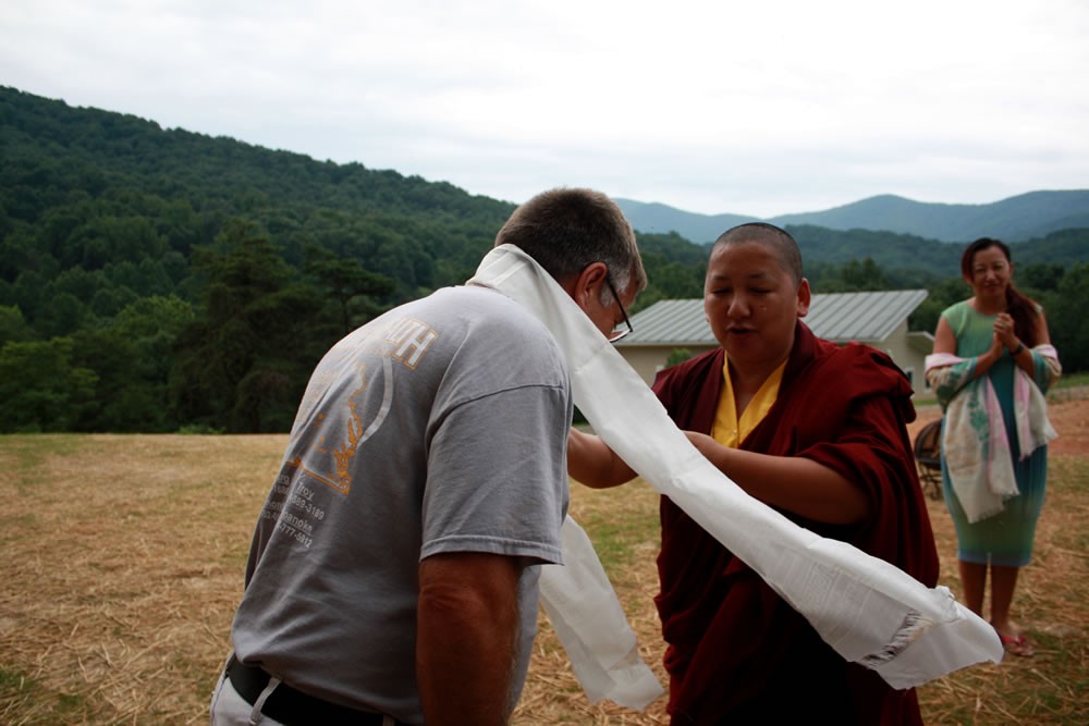 HE Jetsün Khandro Rinpoche presents the ceremonial scarf to Mark Good, the builder of Tashi Chö Dzong.