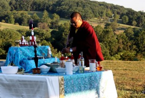 Ven. Acarya Namdrol Gyatso preparing the shrine.