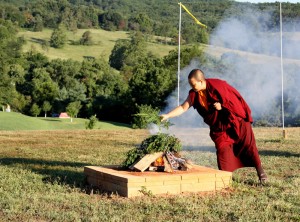 Anila Choenyid tends the sang fire.