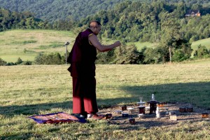 Ven. Acarya Namdrol Gyatso attending to the shrine.