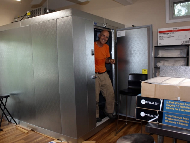 Lama Roar working inside the new walk-in cooler which was installed in the rebuilt kitchen annex.