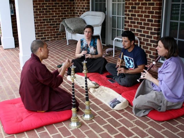 Ven. Thrinley Gyatso la and students during instrument instruction.