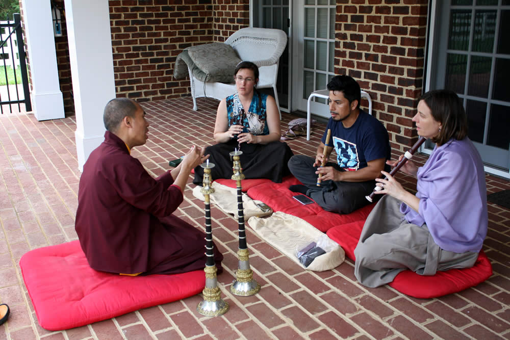 Ven. Thrinley Gyatso la and students during instrument instruction.