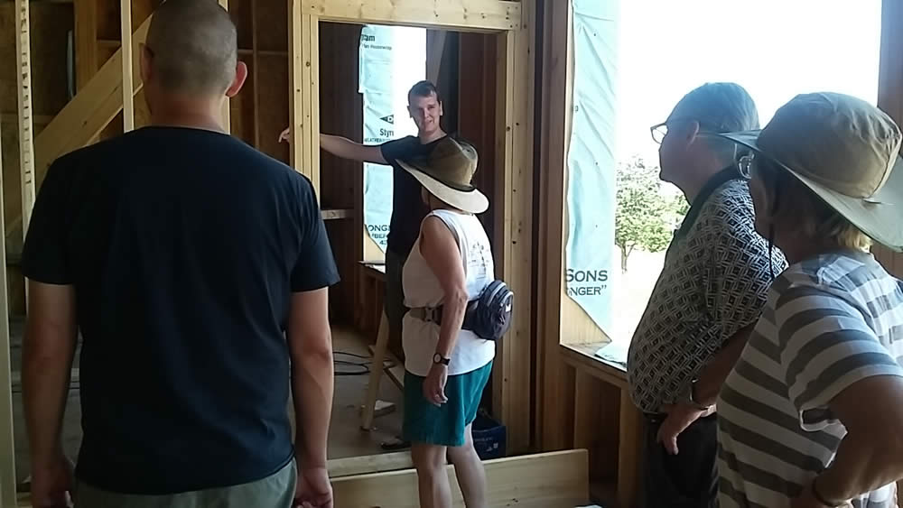 JUNE 10--Britton Bosarge leads sangha members on a tour of the temple.