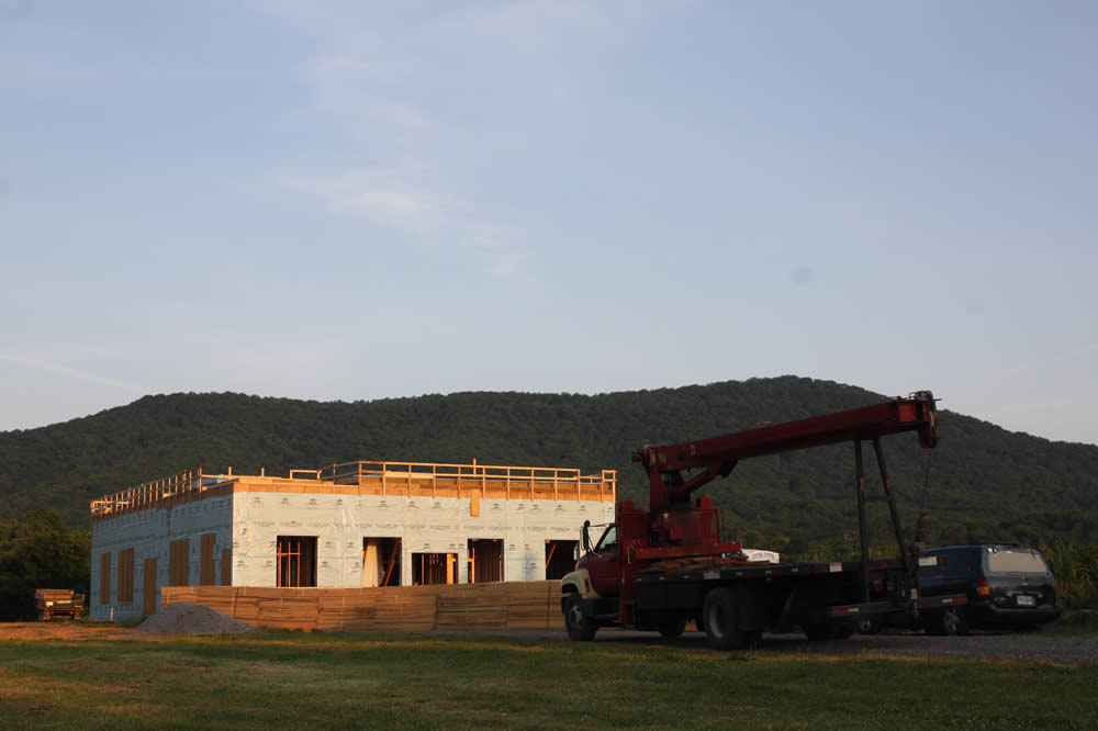 JULY 11--The crane arrives early in the day to raise walls of the 2nd story.