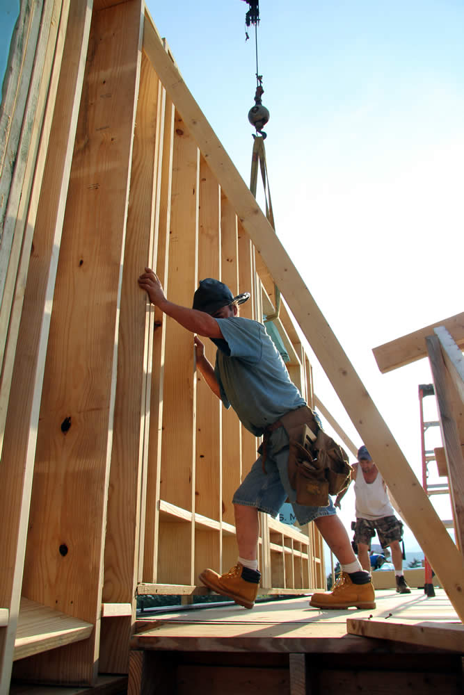 JUNE 11-Workers move the east wall into position.