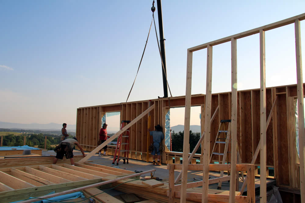 JUNE 13-Workers install the new east wall panel.