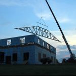 Raising the first roof truss of the temple.