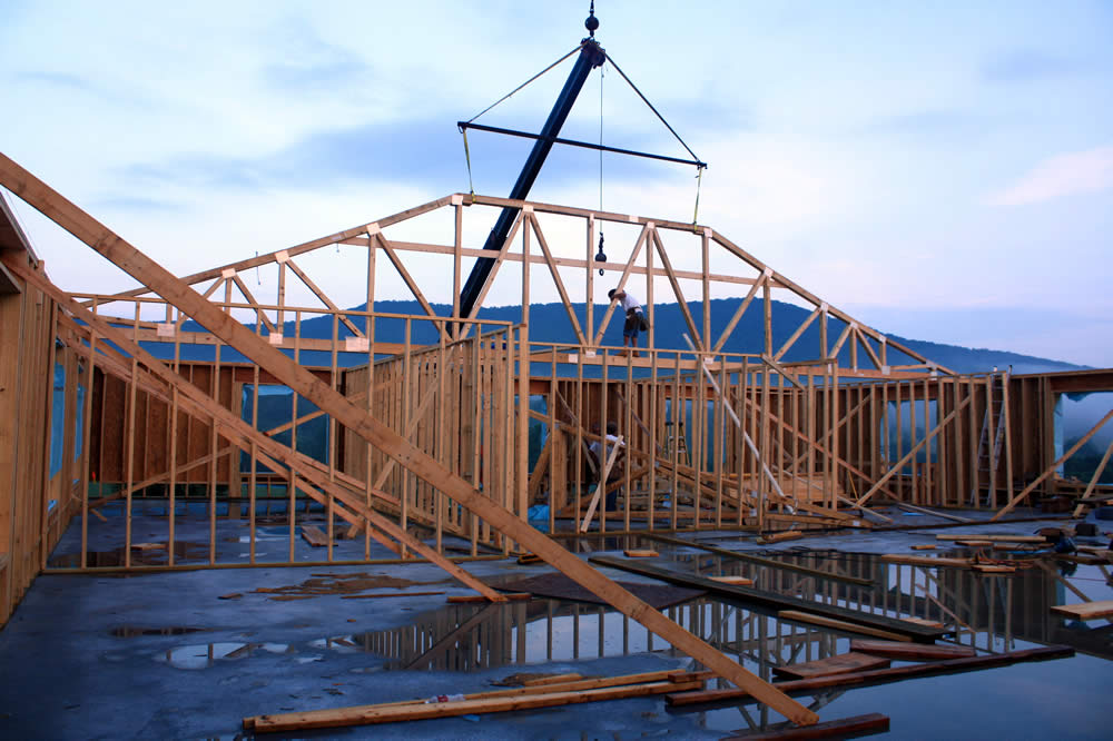 JULY 14—Interior view of first roof truss in position.