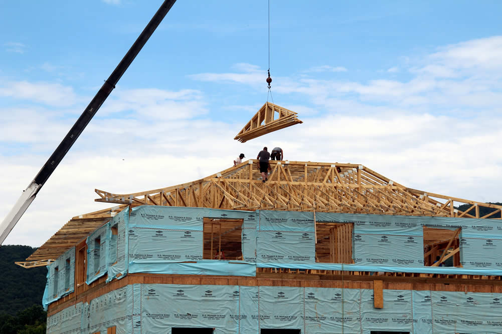 JULY 15-Preparing to install roof peak trusses. The peak will be topped with a golden spire, deer and dharmachakra.