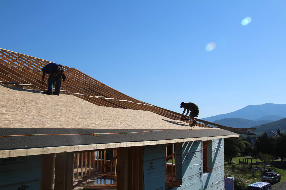 JUNE 20-Workers sheeting the roof of the temple.