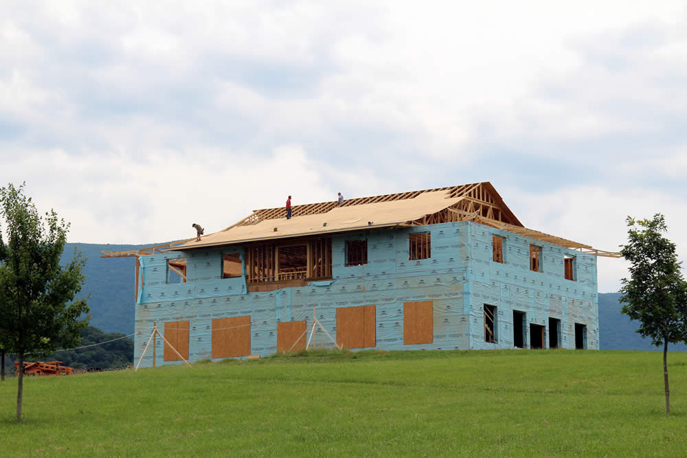 JUNE 20-Roofers sheeting the roof of the temple.