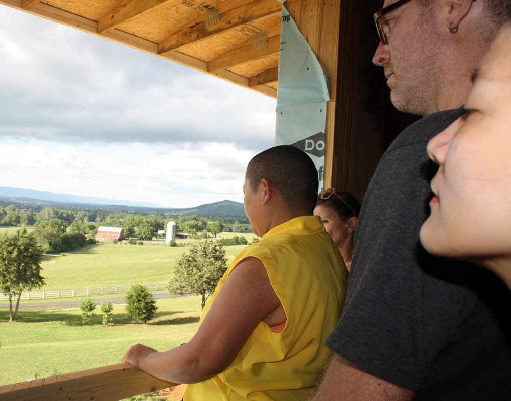 JULY 29-Rinpoche and students admire the view from a 2nd floor window.