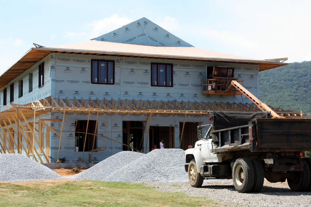 AUGUST 1-Workers lift one of 16 2nd floor windows  into position.