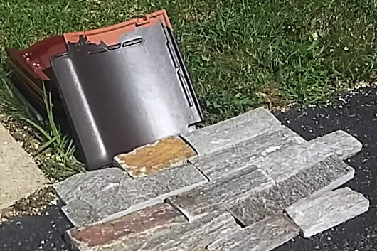 AUGUST 1- Sample of brown roof tile and granite siding to be used on the temple.
