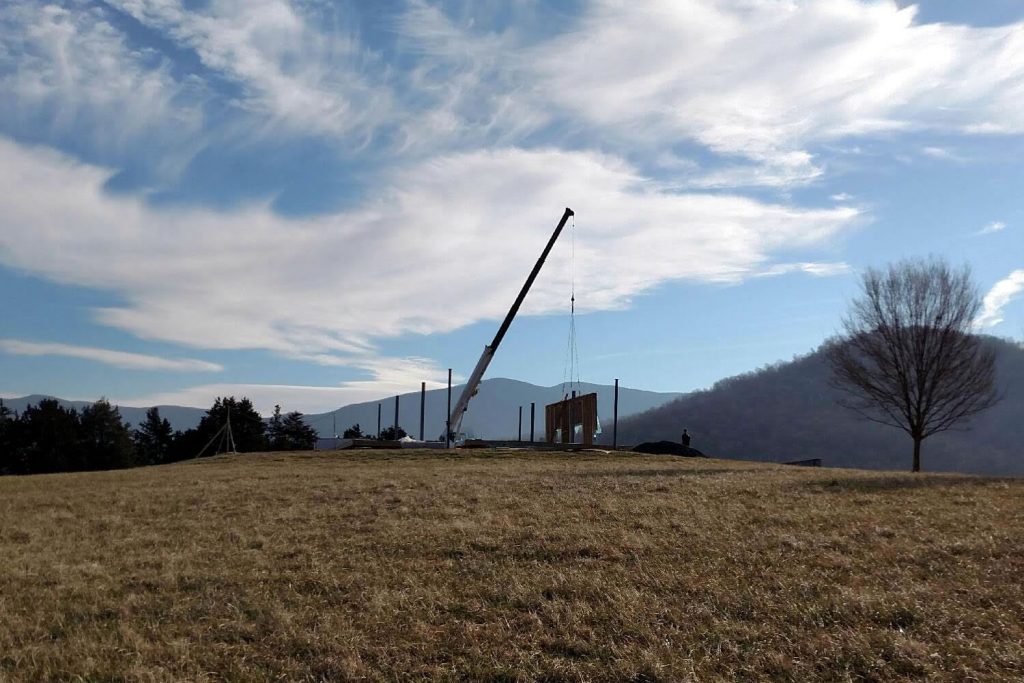 25 FEBRUARY—Early morning view of the crane lifting a section of the southern wall into position.