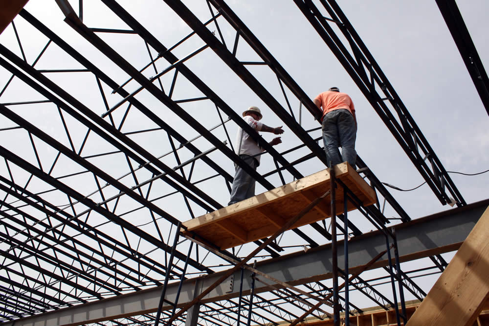 5 APRIL—Workers securing sections of metal joists for the second floor.