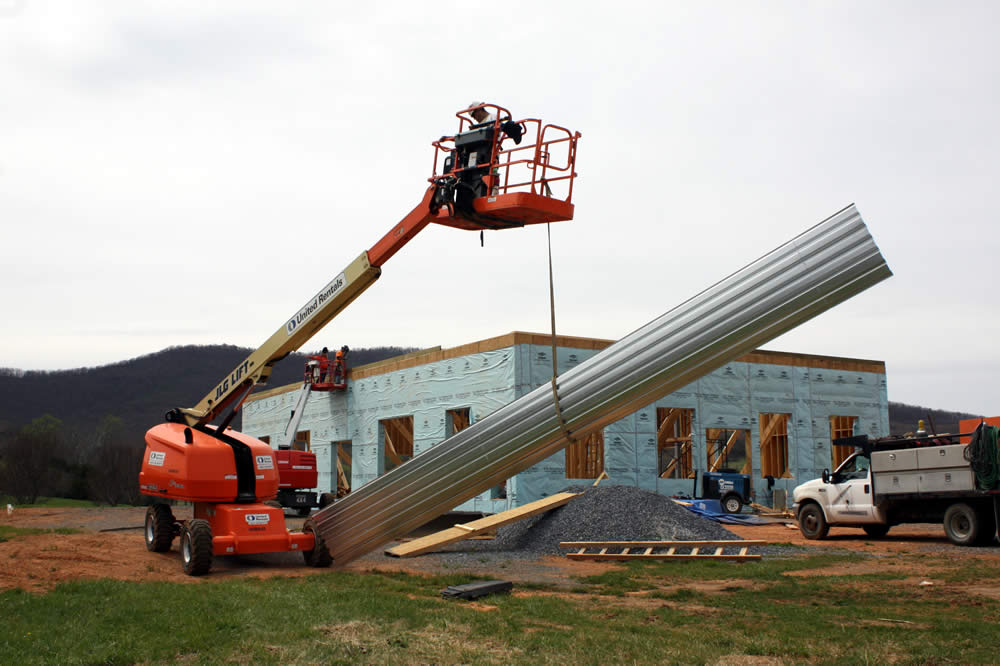 10 APRIL— Lifting a metal panel for the second floor deck of the temple.