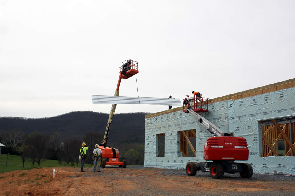 10 APRIL—Lifting a metal panel for the second floor deck of the temple.