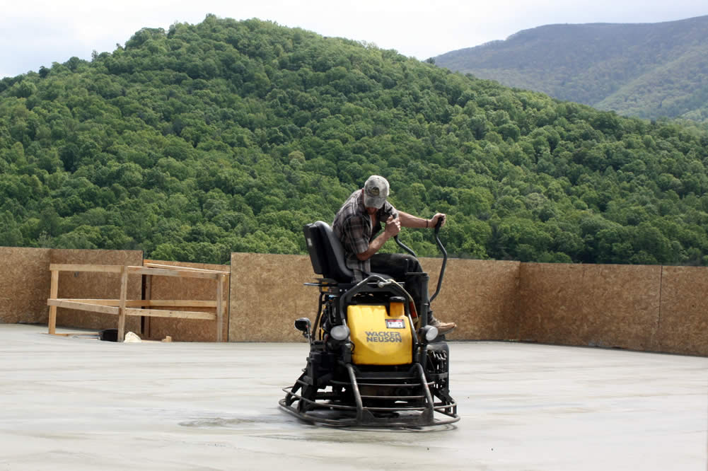 3 MAY&mdash;Smoothing concrete for temple&#039;s second floor.