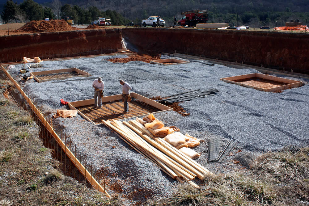 Workers place reinforcing steel bars (rebar) into a pier which will eventually support an important vertical beam.