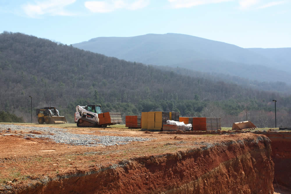 Wall-forms arrive for use in contructing the concrete walls and piers of the foundation.