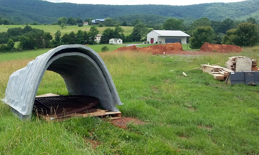 These odd-looking objects which appeared on the land are actually egress wells required by Virginia building codes and will provide for emergency exit from the temple basement.