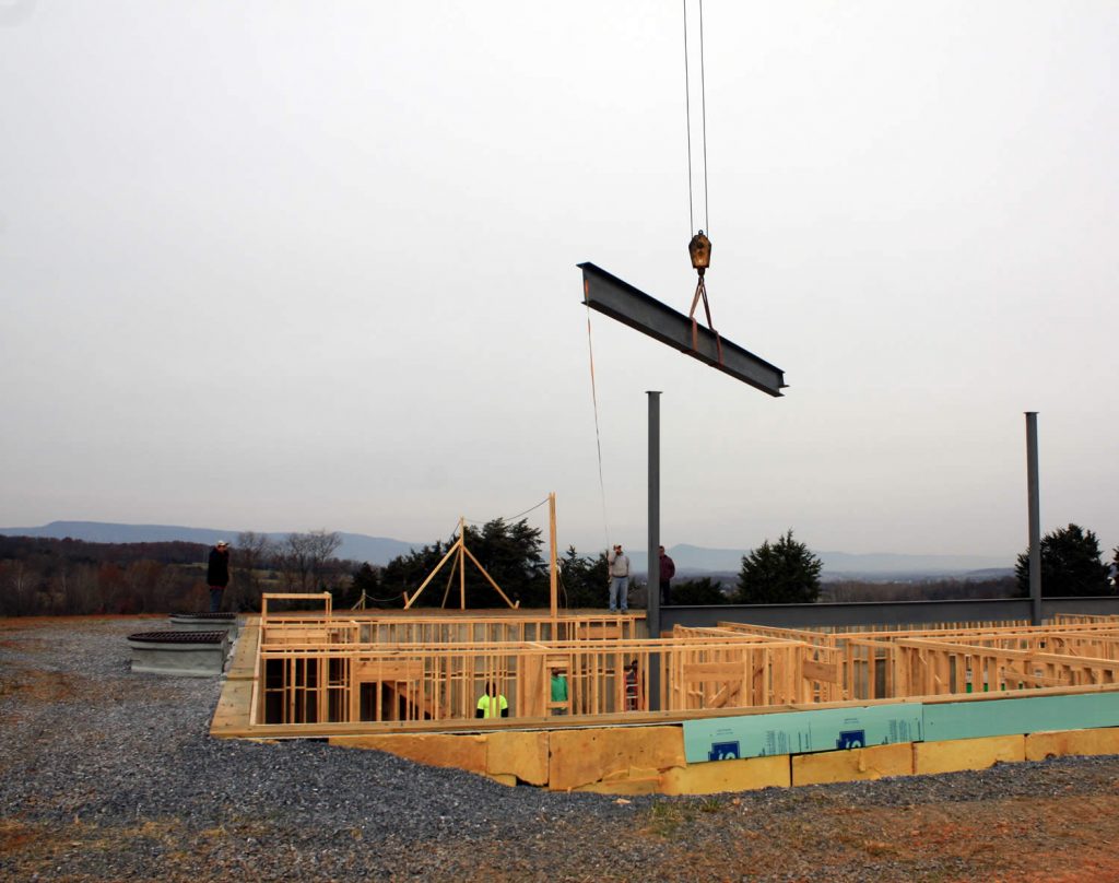 NOVEMBER 28--Lowering a horizontal beam into position.