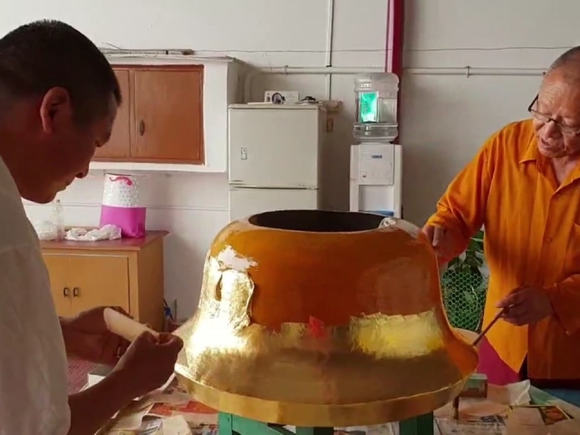 Applying Gold Leaf to A Temple Ornament