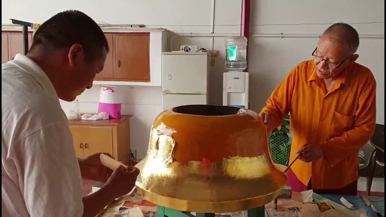 Applying Gold Leaf to A Temple Ornament