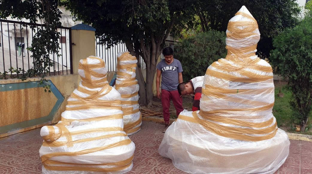 Statues of Shakyamuni Buddha, Guru Rinpoche and Terdag Lingpa, the founder of Mindrolling, are wrapped in India for the ocean-journey to Lotus Garden.