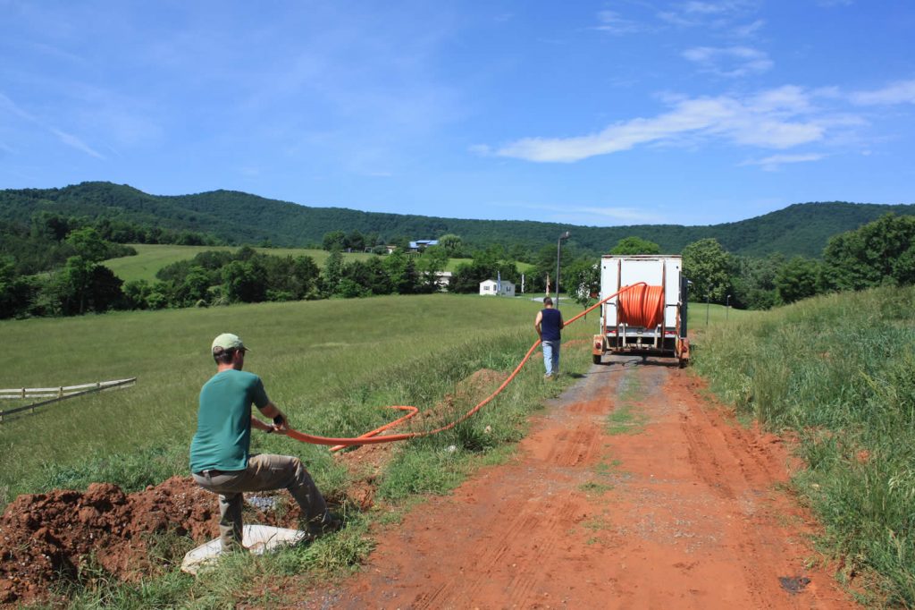 Alex Ryan and Dean Baker laying conduit for the fiber optic cable.