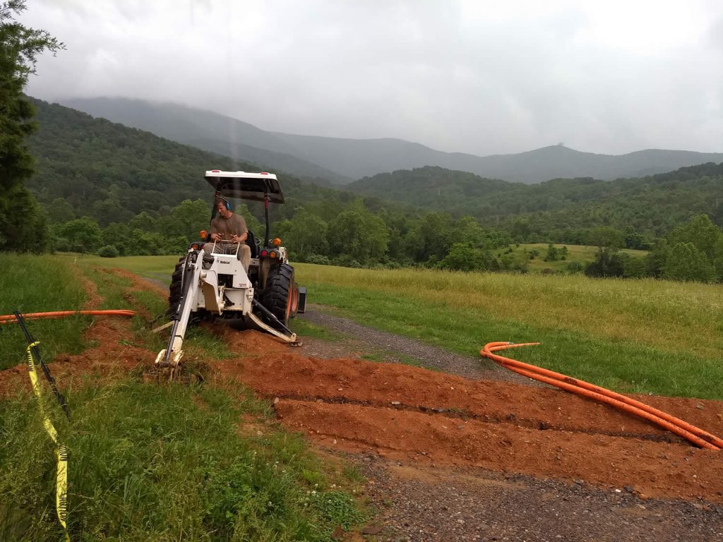 Dean Baker prepares to install a hand-hole in the area of the main residence and temple site