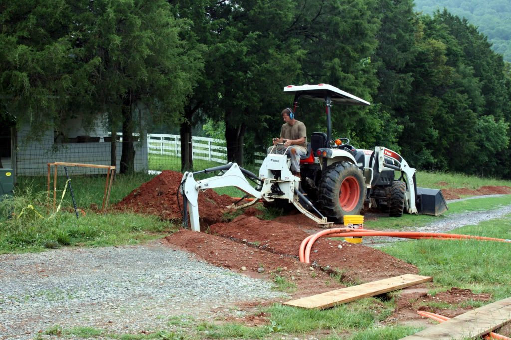 Dean Baker preparing to install a hand-hole near the main residence and temple