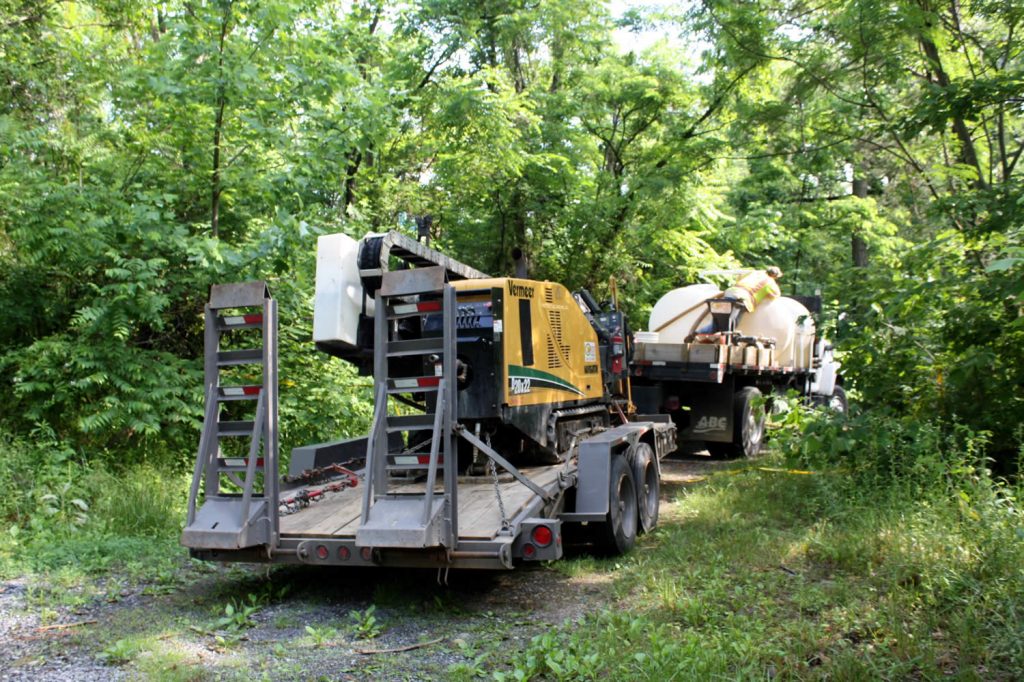 The horizontal drill and water pump truck arrive at Lotus Garden to dig under Mindrolling Drive