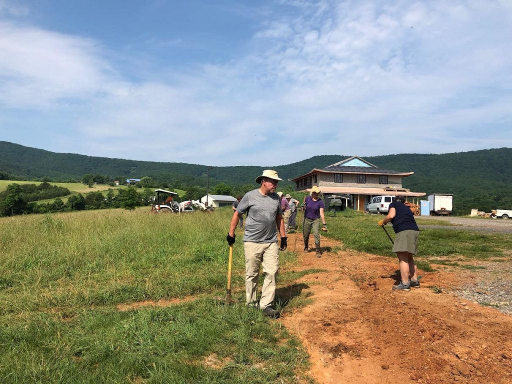 During a spring work-weekend, sangha members worked together to fill many open trenches on the land.