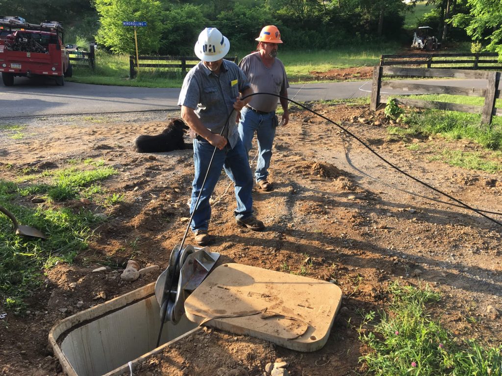 PennLine workers pulling fiber optic cable.