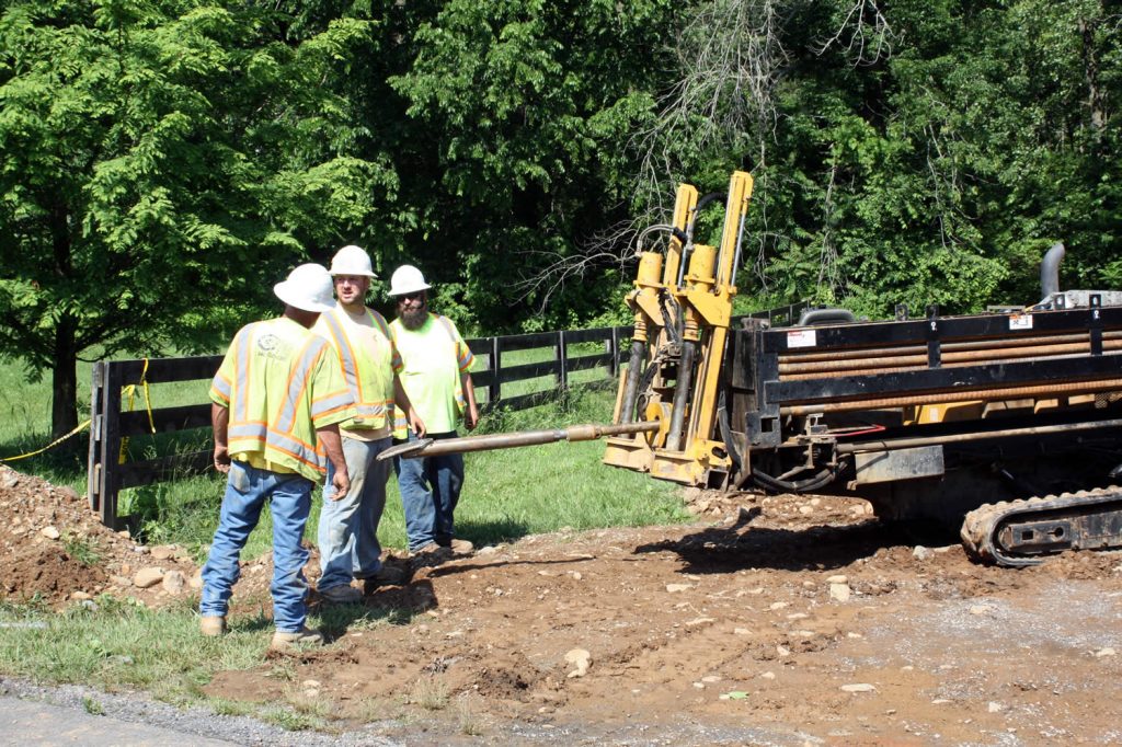 Smartech workers prepare the horizontal drill for digging under Mindrolling Drive