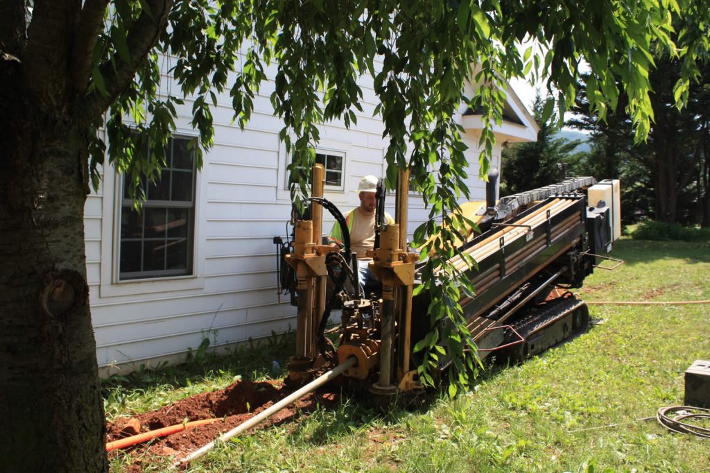 The horizontal driller tunneling under the sidewalk near the Main Residence