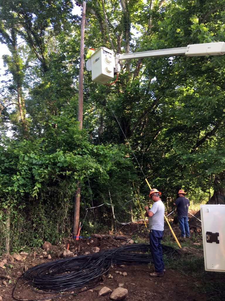 PennLine workers prepare to puPreparing to pull fiber optic cable from the Shentel hardware on a SVEC electrical pole on Pine Grove Road.