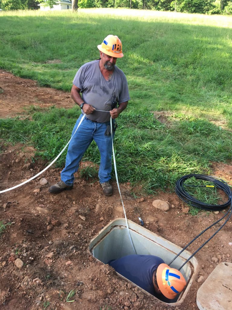 PennLine workers pulling fiber optic cable.