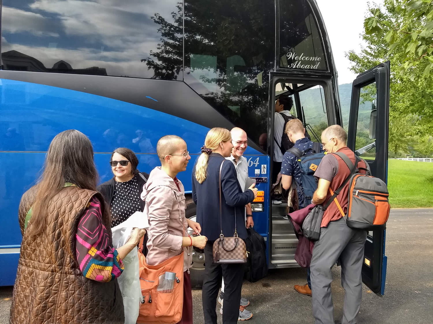 Lotus Garden Sangha Members board bus for trip to airport