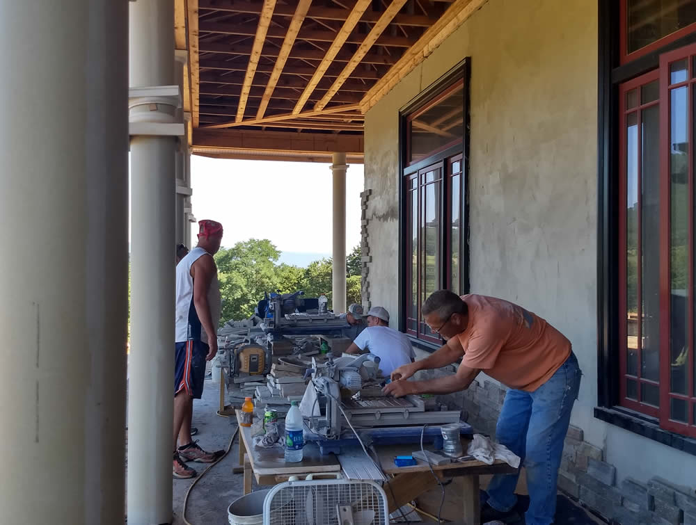Stone masons at work on temple's south wall, summer 2019